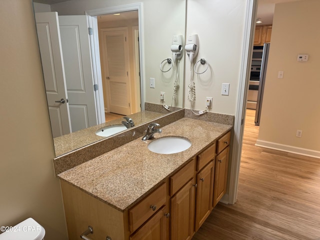 bathroom with vanity and hardwood / wood-style flooring