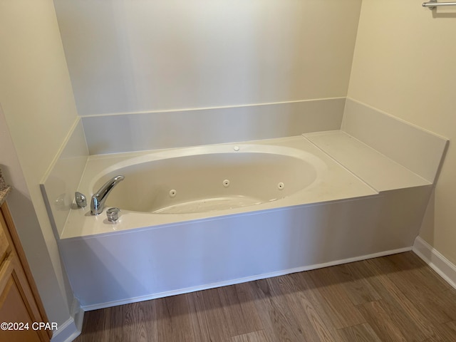 bathroom featuring hardwood / wood-style floors and a tub