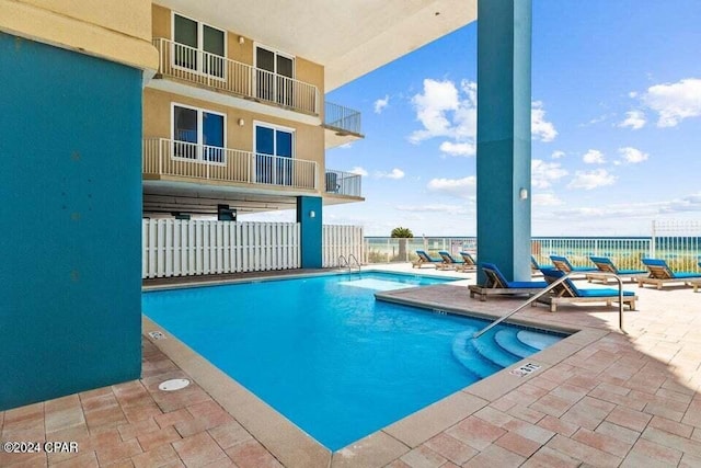 view of swimming pool with a patio