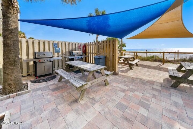 view of patio / terrace featuring a grill and a water view