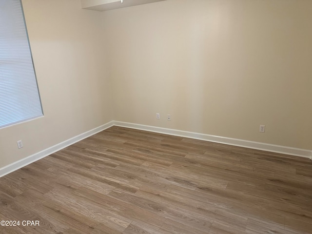 unfurnished room with wood-type flooring