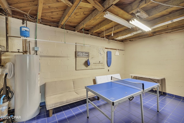 game room with dark tile patterned floors and electric water heater