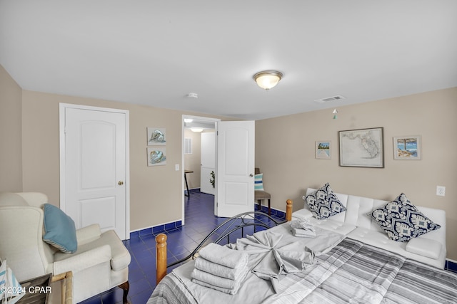 bedroom with dark tile patterned floors