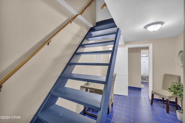 stairs featuring tile patterned flooring