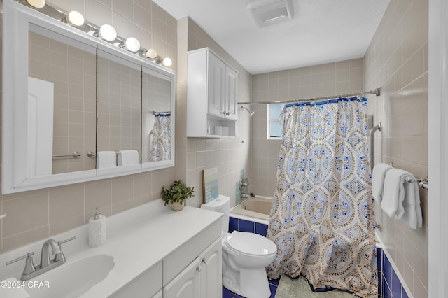 full bathroom with shower / tub combo with curtain, tile walls, decorative backsplash, vanity, and toilet