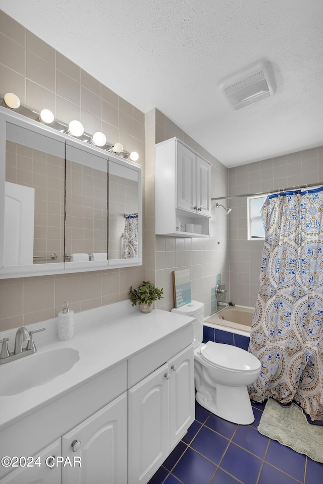 full bathroom featuring tile walls, tile patterned flooring, a textured ceiling, and shower / bathtub combination with curtain