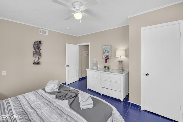 bedroom featuring crown molding, ceiling fan, and dark tile patterned flooring