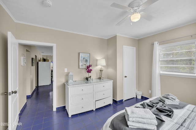 bedroom with crown molding, ceiling fan, and white fridge