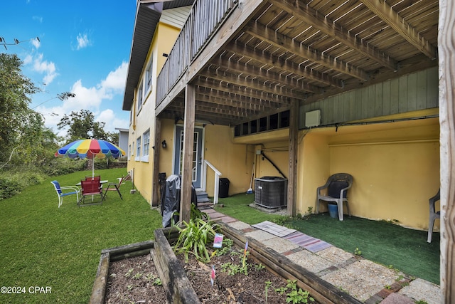 view of side of home featuring a yard and central air condition unit