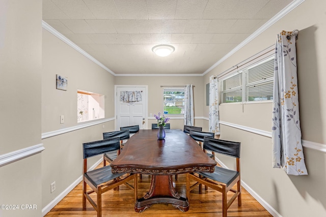 dining space with crown molding and wood-type flooring