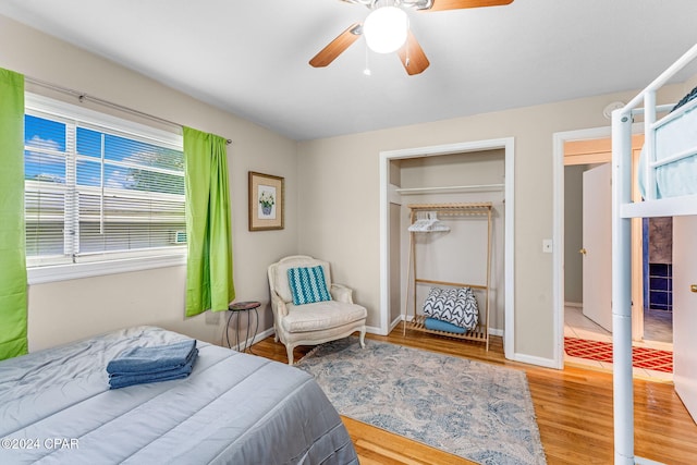 bedroom with hardwood / wood-style floors, ceiling fan, and a closet