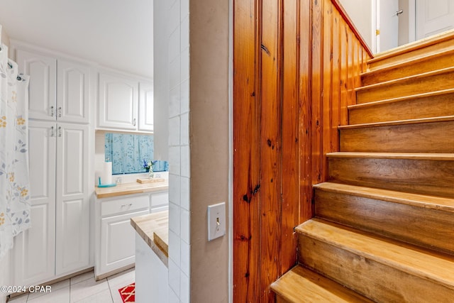 stairs featuring tile patterned flooring