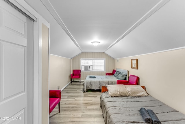 bedroom with lofted ceiling and light wood-type flooring