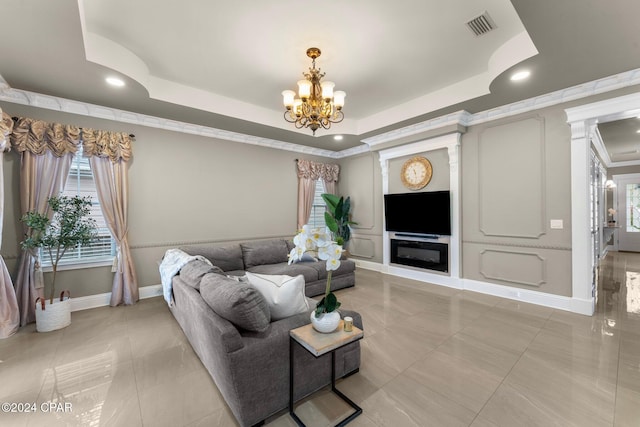 living room featuring a raised ceiling, a wealth of natural light, tile patterned flooring, and an inviting chandelier