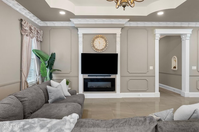 living room featuring ornate columns and a chandelier