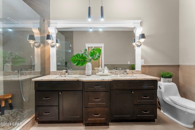 bathroom with a shower with door, vanity, and toilet