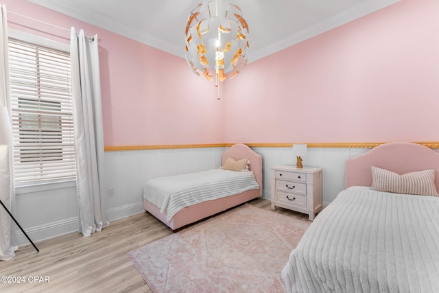 bedroom featuring light hardwood / wood-style floors and ornamental molding