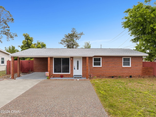 single story home with a front lawn and a carport