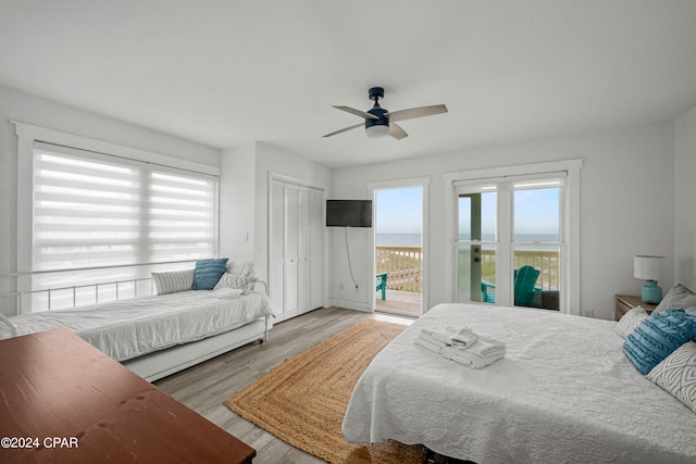 bedroom featuring a closet, access to outside, ceiling fan, and light wood-type flooring