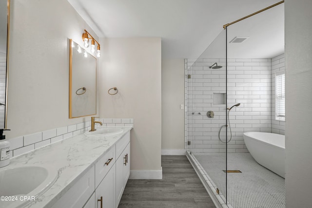 bathroom featuring wood-type flooring, plus walk in shower, and vanity