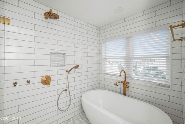 bathroom featuring shower with separate bathtub, tile walls, and tile patterned floors