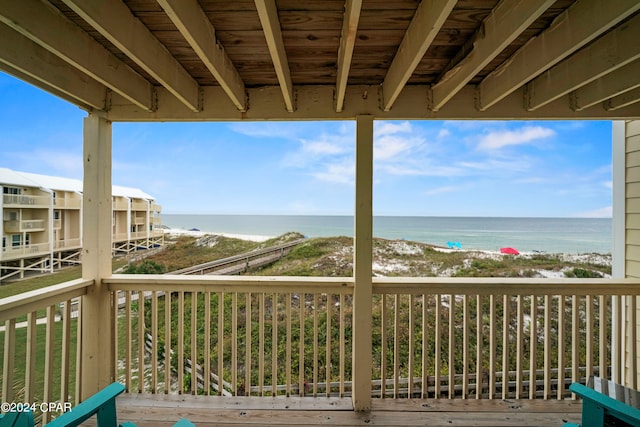 deck featuring a beach view and a water view