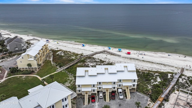 birds eye view of property featuring a view of the beach and a water view