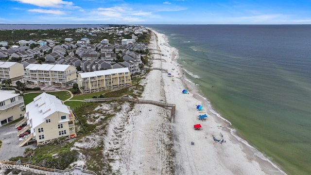 birds eye view of property with a beach view and a water view