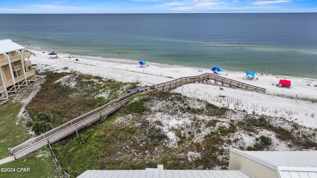 drone / aerial view with a beach view and a water view