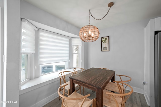 dining room with hardwood / wood-style flooring and a notable chandelier