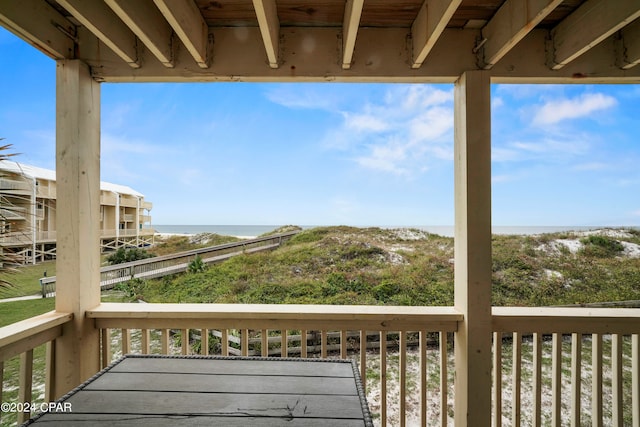 wooden terrace featuring a water view