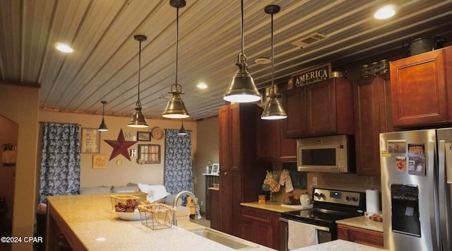 kitchen with sink, decorative light fixtures, and appliances with stainless steel finishes