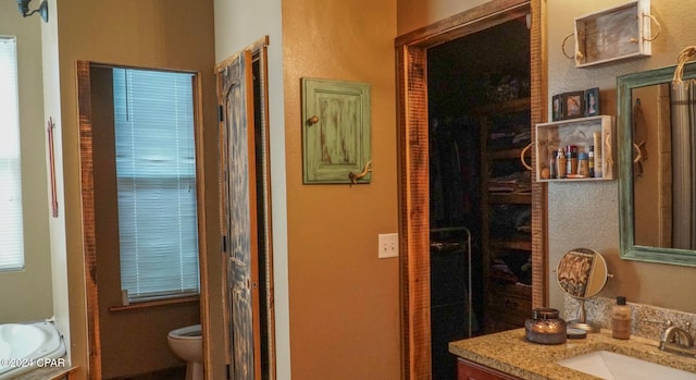 bathroom with vanity and toilet