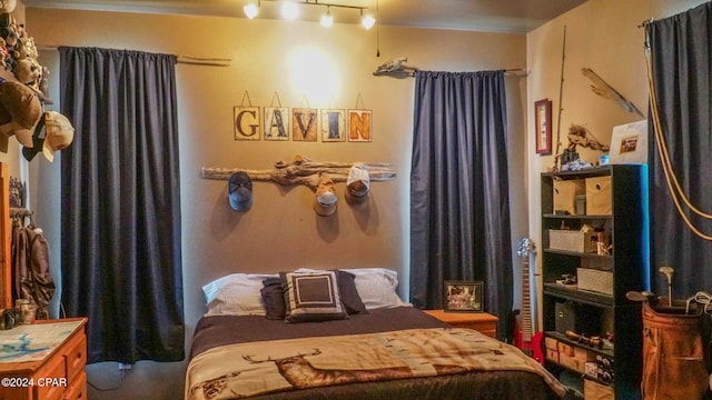 bedroom featuring rail lighting