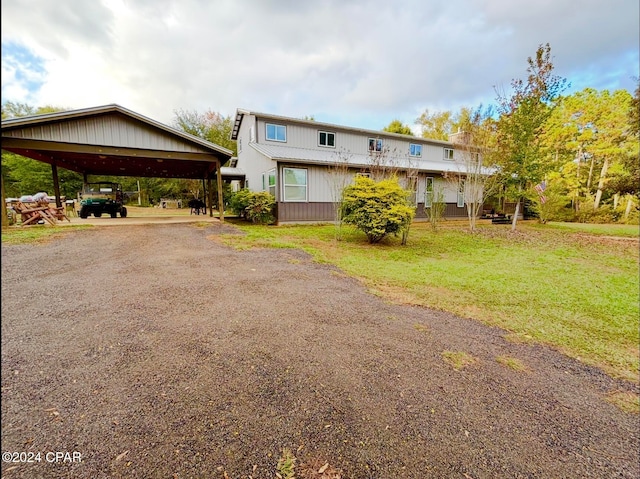 view of front facade with a front lawn and a carport