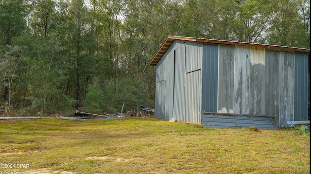 view of outdoor structure with a lawn