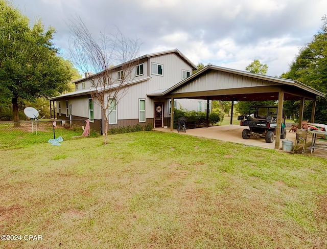 back of house featuring a yard and a carport