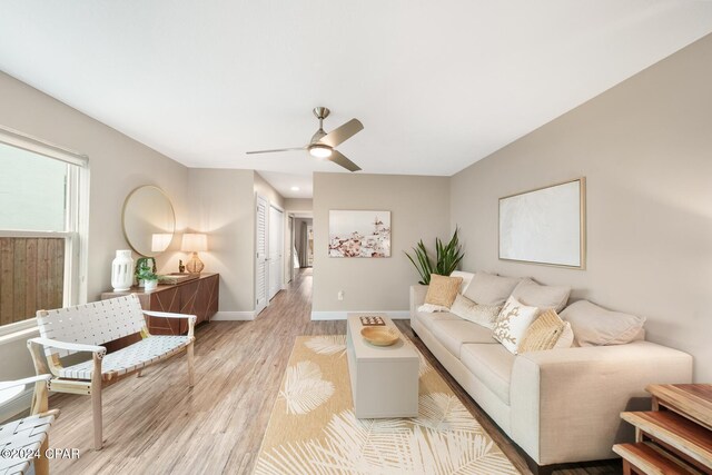 living room with ceiling fan and light hardwood / wood-style floors