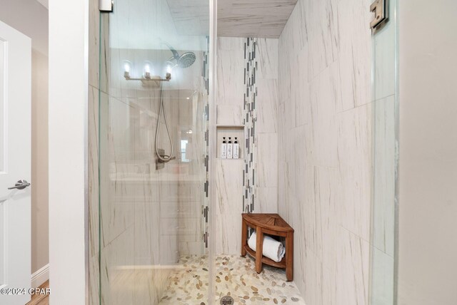 bathroom with a shower with shower door