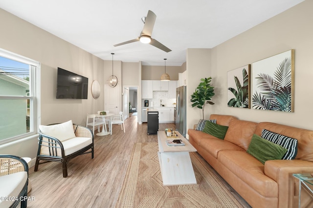 living room featuring light wood-style floors and ceiling fan