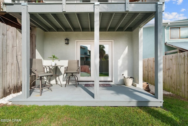 view of patio featuring fence and a deck