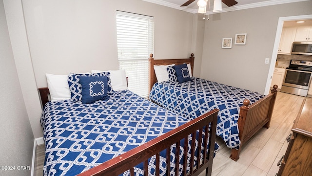 bedroom with ornamental molding, ceiling fan, and light wood-type flooring