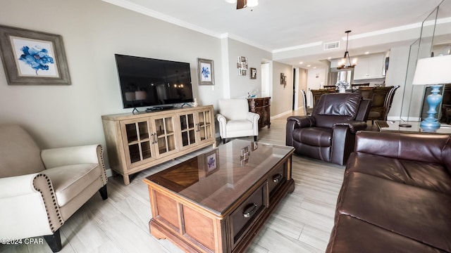 living room with an inviting chandelier and crown molding