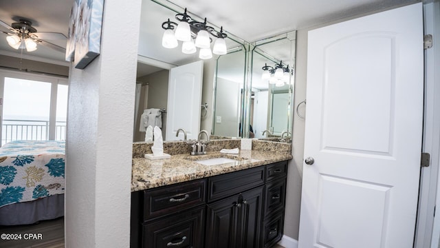 bathroom featuring crown molding, hardwood / wood-style floors, vanity, and ceiling fan