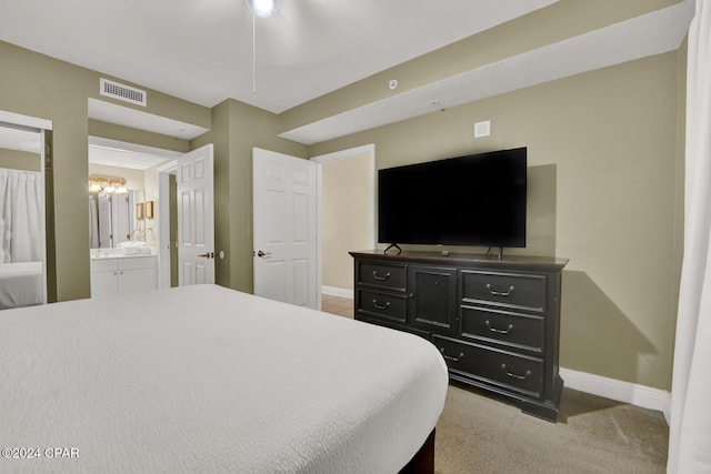 carpeted bedroom featuring ensuite bath