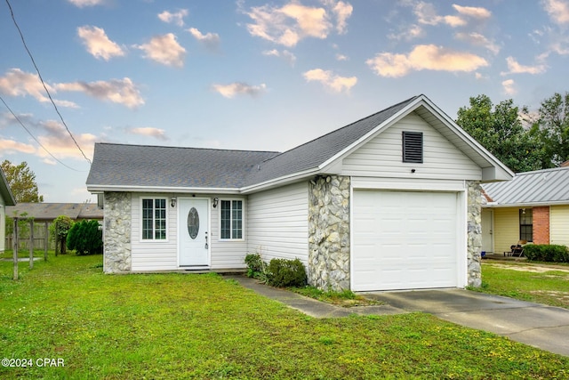 ranch-style house with a garage and a front lawn