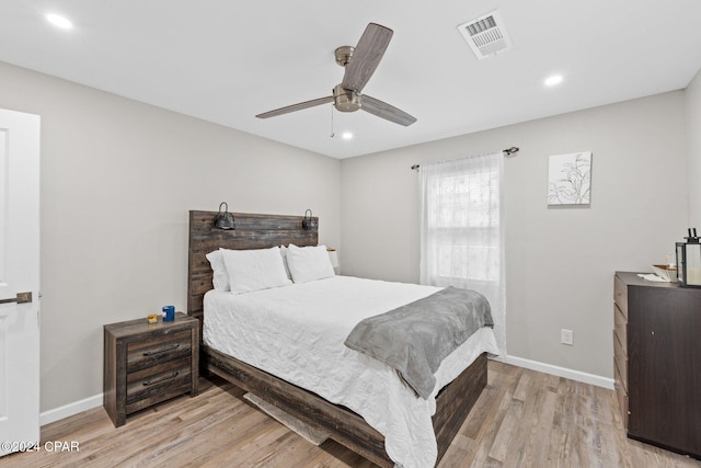 bedroom with ceiling fan and light wood-type flooring