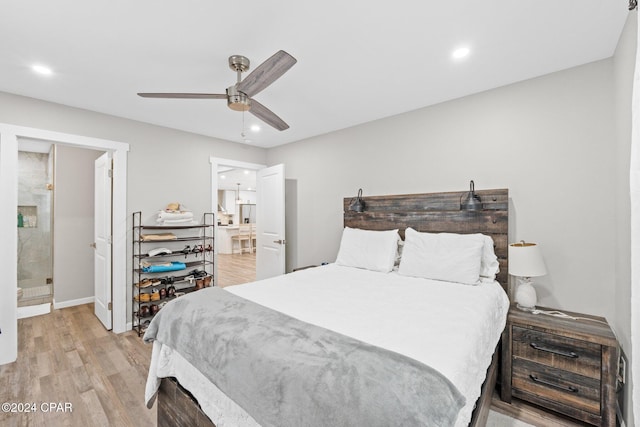 bedroom with ceiling fan, light hardwood / wood-style floors, and ensuite bath