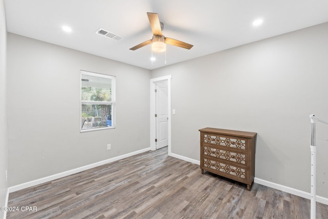 empty room with ceiling fan and wood-type flooring