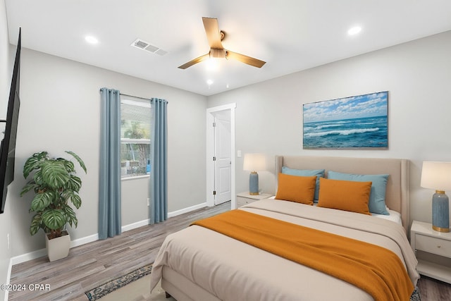 bedroom with ceiling fan and wood-type flooring